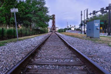 Tampa Bay Hillsborough River Train Crossing and Trestle in upright position lights and reflections on the Hillsborough riverwalk clipart