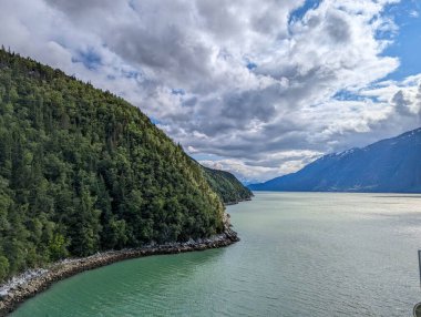 Beautiful scenery of the water and the Mountains of Skagway clipart