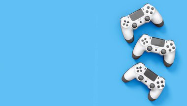 Gerçekçi beyaz video oyunu joystickleri ya da mavi arka planda oyun pedleri. Bulut oyunu ve oyun alanı çalışma alanı konsepti için 3 boyutlu görüntüleme