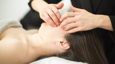 Yüz masajı yapan bir masörün elleri. Kozmetik prosedürler. Rahatlama. - Yakın çekim. Yumuşak odak