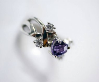 Bu çarpıcı yüzük, zarif gümüşlerle işlenmiş parıldayan elmaslarla çevrili kalp şeklinde bir ametist içeriyor. Her kuyumcu için mükemmel..