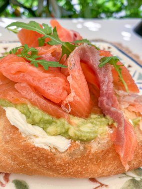 Gourmet Avocado and Salmon Toast with Fresh Arugula. High quality photo clipart