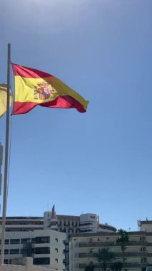 Gran Canaria 'da güneşli bir günde İspanyol Bayrağı Rüzgarda Dalgalanıyor. Yüksek kalite 4k görüntü