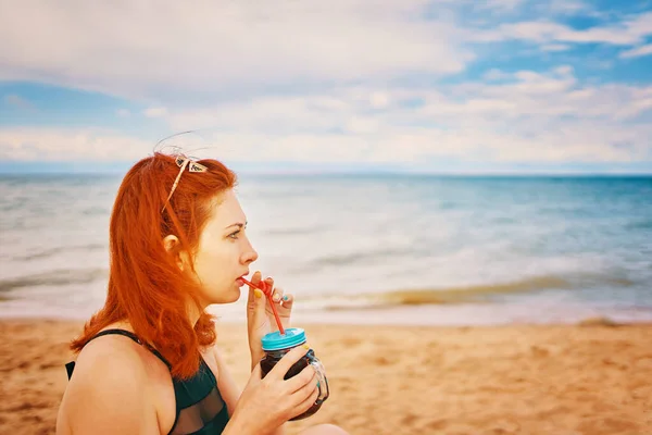 Roodharig Meisje Een Badpak Zit Het Strand Met Een Cocktail — Stockfoto