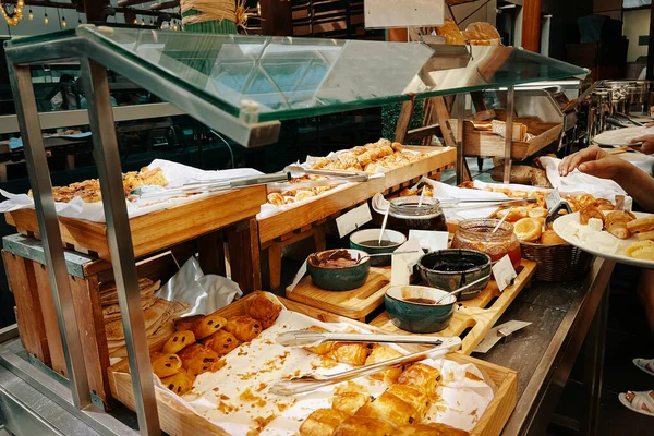 The hotel breakfast buffet features a diverse array of fresh pastries and crispy morning croissants.