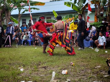 Balikpapan-Indonesia September 1st,2024 Fighting kuda lumping player,Kuda lumping: A traditional Javanese art in which dancers ride wooden or bamboo horses clipart