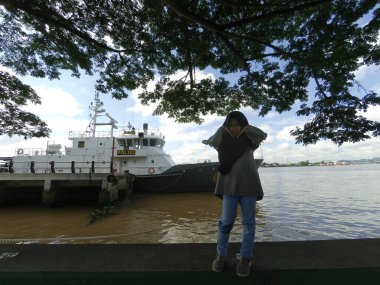 Samarinda-East Kalimantan January 04, 2020 Indonesian police boat anchored on the bank of the Mahakam river clipart