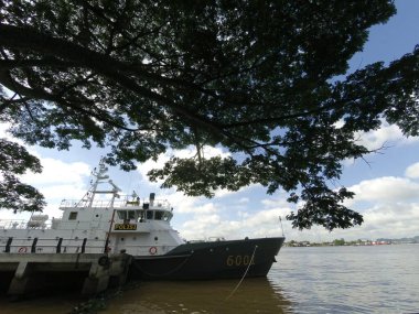 Samarinda-East Kalimantan January 04, 2020 Indonesian police boat anchored on the bank of the Mahakam river clipart