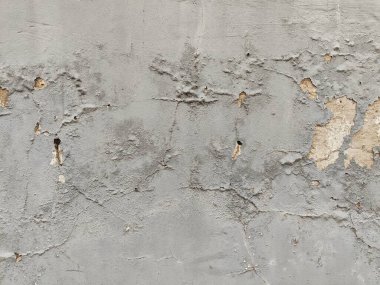 Duvarın arka planında beton desenli çatlak boyası olan gri ışık..