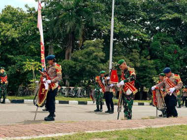 Balikpapan-East Kalimantan 09 November 2024 Indonesian National Armed Forces Day, Soldiers Hold Marching Band Parade with Various Types of Complete Combat Vehicle Uniforms at Merdeka Park clipart