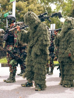 Balikpapan-East Kalimantan 09 November 2024 Indonesian National Armed Forces Day, Soldiers Hold Marching Band Parade with Various Types of Complete Combat Vehicle Uniforms at Merdeka Park clipart