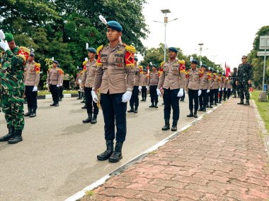 Balikpapan-East Kalimantan 09 November 2024 Indonesian National Armed Forces Day, Soldiers Hold Marching Band Parade with Various Types of Complete Combat Vehicle Uniforms at Merdeka Park clipart