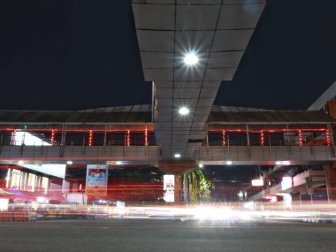 Balikpapan-East kalimantan November 07,2024 light trails from vehicles on the pedestrian bridge in front of Balikpapan Plaza, this place is a favorite spot for night photography,long exposure clipart