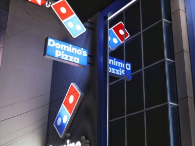 Balikpapan-East Kalimantan November 06,2024 A view of Domino's pizza shop from outside at night,logo,icon,neon box clipart