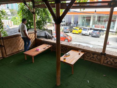 Balikpapan-East Kalimantan November 23,2024 Wooden tables and chairs on the terrace of a traditional coffee shop and its like the vintage cafe clipart