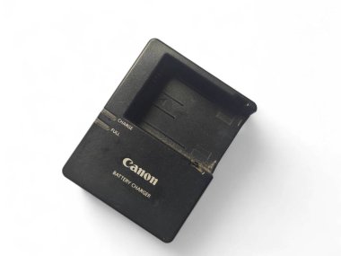 Balikpapan-Endonezya 11 Aralık 2024 Beyaz zemin üzerinde izole Canon DSLR eos 550d batarya şarj etmek için Batarya adaptörü