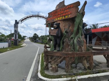 Balikpapan December 24,2024 Statue and entrance gate of The Environmental Education Tourism Area (KWPLH), or known as the Honey Bear Center, is an environmental education facility at balikpapan city clipart