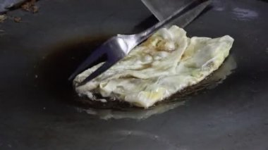 Bir Martabak Telur yapma ya da pişirme süreci. Tavada sıcak yağ ile kızartılan aperatifler yumurta, et, sebze ve baharatla dolu undan yapılır..