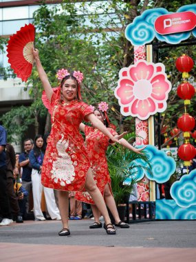 Balikpapan-Indonesia January 29, 2025  Beautiful female dancer wearing traditional Chinese clothing in the Chinese New Year festival at balikpapan clipart