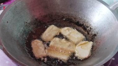 Tempe unu fırının üstünde sıcak yağda kızartılıyor, Endonezya geleneksel yemek pişirme süreci, çıtır çıtır ve altın dokular..