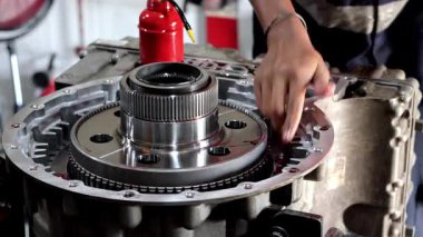 26 Ağustos 2025 'te Balikpapan-Endonezya Tamiratı sırasında bir tamircinin eli, debriyaj kaplamasını karmaşık bir şanzıman montajına kayganlaştırmak için kırmızı yağ tenekesi kullanır..