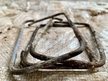 Top-down flat-lay of rusted metal rebar frame. Sharp detail highlights grunge and texture. Perfect for themes: construction, industrial, background, resilience.