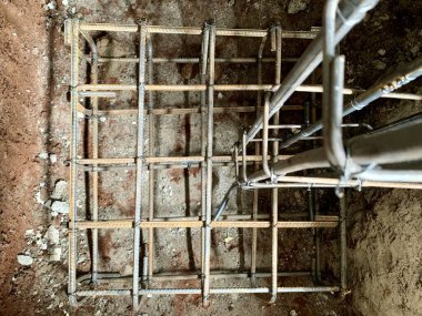 Close-up of reinforced steel rebar grid for concrete foundation footing, captured from above with sharp focus. Perfect for themes of construction, engineering, and architecture.