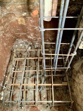 Close-up of reinforced steel rebar grid for concrete foundation footing, captured from above with sharp focus. Perfect for themes of construction, engineering, and architecture.
