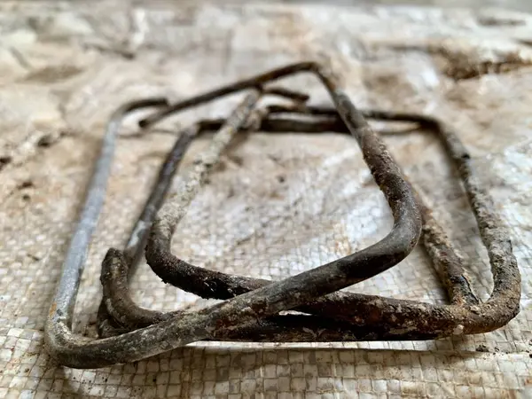 Top-down flat-lay of rusted metal rebar frame. Sharp detail highlights grunge and texture. Perfect for themes: construction, industrial, background, resilience.