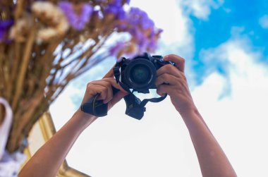 Arkaplan pankartı elinde kamera olan biri mavi gökyüzü