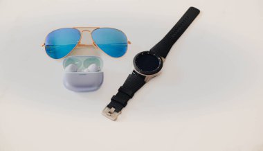 Elevate your look with premium blue aviator sunglasses, a sleek smartwatch, and wireless earbuds. The perfect modern accessories for style and functionality clipart