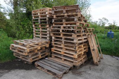 Neatly stacked pallets form uniform piles, ready for use in industry or transportation clipart