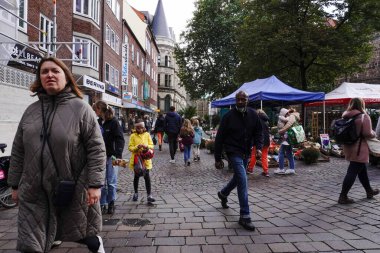 A crowded street near a market with a lively atmosphere - Bremen, Germany 28.09.2024 clipart