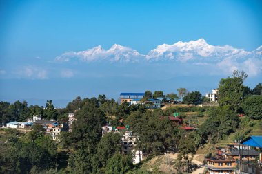 Himalayalar 'ın eteklerindeki küçük bir köyün manzarası. Nepal' in arka planında kar zirveleri var..