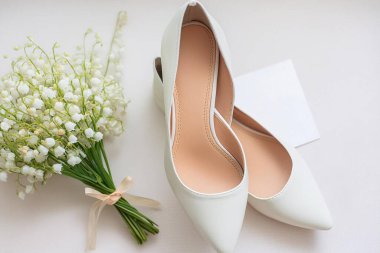 Yerde alyansları olan beyaz ayakkabılar