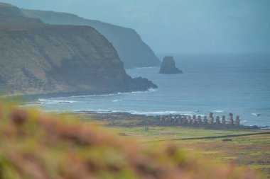 View from the Moai factory on Easter Island or Rapa Nui over the surroundings. Very green. Bad weather. clipart