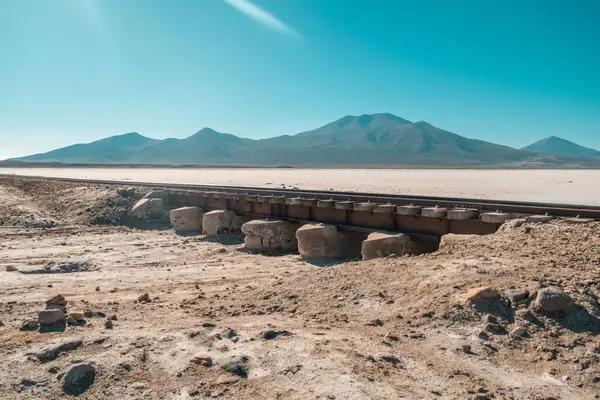 Salar de Uyuni tuzlu yol gezisi: Chirguana ve Avaroa gibi çöllerde Cerro Chirguana dağı yakınlarında eski tren rayları ve Paruma Dağı 'nın 4000 metre yüksekliğini görmek.