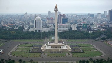 The National Monument (Monas) in Jakarta, Indonesia, stands tall in the center of Merdeka Square. Surrounded by lush greenery and cityscape, this iconic landmark symbolizes the nation's independence and is a popular tourist attraction. clipart