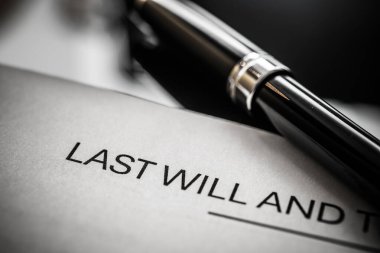 Bir dolmakalemin yanındaki son vasiyetname belgesinin yakından incelenmesi, mülkiyet planlaması ve kişisel miras üzerindeki yasal belgelerin önemini vurguluyor..