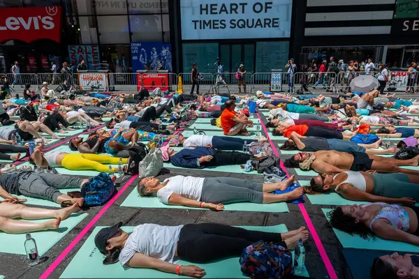 stock image New York NY USA-June 20, 2024 Yoga practitioners pack Times Square in New York in the sweltering heat to practice yoga on the summer solstice, first day of summer,