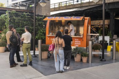 New York NY USA-October 9, 2024 Customers line up for Mexican street food at La Plaz at the Standard High Line Hotel in the Meatpacking District in New York clipart