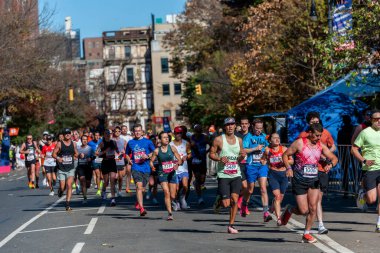 New York NY USA-November 3, 2024 Runners pass through Harlem in New York near the 22 mile mark near Mount Morris Park  the TCS New York City Marathon clipart