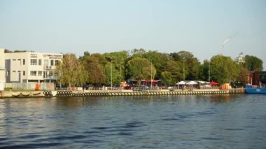 Gdansk, Polonya. Gün batımında nehirde bir tekne yolculuğu ve kıyıya demir atma. Yüksek kalite 4k görüntü