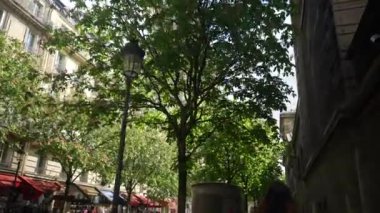 Beyaz önlüklü bir kız Paris sokaklarında yürüyor. Yüksek kalite 4k görüntü