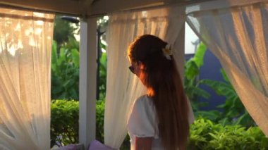 Beyazlı bir kız çardaktan çıkıyor. Yüksek kalite 4k görüntü