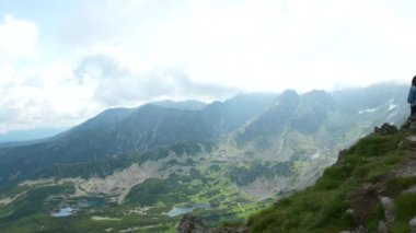 Kasprowy Wierch, Zakopane 'e tepeden bakan bir dağın tepesinde oturan kız. Yüksek kalite 4k görüntü