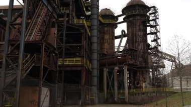 Terk edilmiş bir sanayi bölgesinin paslı yapıları, yaşlanma teknolojisinin ve zengin tarihin etkilerini açıkça yansıtıyor.