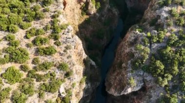 A serene aerial shot of Kapuz Canyon, highlighting its tranquil turquoise waters flowing through the rugged landscape. On a bright, crowd free day, the canyons natural beauty shines.