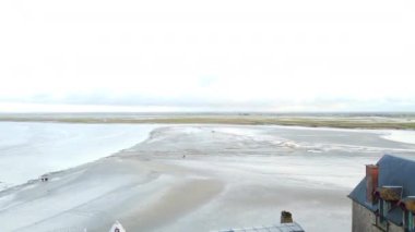 Mont Saint-Michel 'den çatı manzarası, geniş gelgit düzlüklerine ve kıyı manzarasına nefes kesici bir bakış sunuyor..