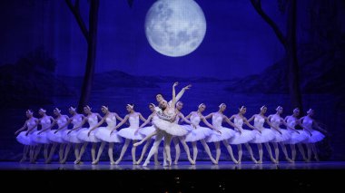 Ballerinas performing in tutus and pointe shoes in the ballet Swan Lake, Wedge pose from the White Adagio. Shooting in Paris, France 11.10.2024 clipart